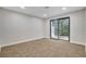 Cozy bedroom with plush carpeting, sliding glass door to outside, and neutral tones at 1600 Becke Cir, Las Vegas, NV 89104