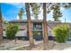 Two-story home with mature trees and landscaping in the front yard at 1600 Becke Cir, Las Vegas, NV 89104
