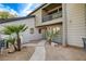 Exterior home shot features a charming walkway, lush landscaping, and a private balcony at 1600 Becke Cir, Las Vegas, NV 89104