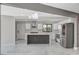 Modern kitchen with stainless steel appliances, white cabinets, and designer island at 1600 Becke Cir, Las Vegas, NV 89104
