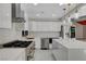 Modern kitchen featuring stainless steel appliances, white cabinetry, and a spacious marble island at 1600 Becke Cir, Las Vegas, NV 89104