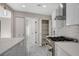 Contemporary kitchen design with hexagon backsplash, modern stainless steel appliances, and white cabinetry at 1600 Becke Cir, Las Vegas, NV 89104