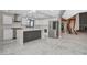 Open kitchen featuring marble floors, an island, stainless steel appliances, and seamless white cabinetry at 1600 Becke Cir, Las Vegas, NV 89104