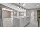 Bright kitchen boasts marble floors, a large island with marble countertop, and modern pendant lighting at 1600 Becke Cir, Las Vegas, NV 89104
