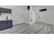 Bright room with a small kitchenette, modern cabinets, and wood-style flooring at 1600 Becke Cir, Las Vegas, NV 89104