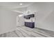 Bright room featuring a small kitchenette with sleek cabinets, wood-style flooring and modern finishes at 1600 Becke Cir, Las Vegas, NV 89104