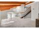 Expansive living room with wood beam ceilings, staircase, fireplace, and marble flooring throughout at 1600 Becke Cir, Las Vegas, NV 89104