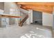 Elegant living room with striking fireplace, vaulted ceilings, and adjacent staircase at 1600 Becke Cir, Las Vegas, NV 89104
