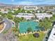 Aerial view of a townhouse complex with tennis courts and lush landscaping at 163 Greenbriar Townhouse Way, Las Vegas, NV 89121