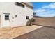 View of the back of the house and backyard with patio area and partial landscaping at 163 Greenbriar Townhouse Way, Las Vegas, NV 89121