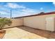 Enclosed backyard featuring a small garden and a mixture of concrete and stone paving at 163 Greenbriar Townhouse Way, Las Vegas, NV 89121