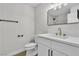 Modern bathroom featuring updated sink, toilet, and light fixtures at 163 Greenbriar Townhouse Way, Las Vegas, NV 89121