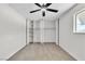 The bedroom has a ceiling fan and closet with opened doors and shelves inside at 163 Greenbriar Townhouse Way, Las Vegas, NV 89121
