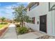 Charming two-story home with a well-manicured lawn and mature landscaping at 163 Greenbriar Townhouse Way, Las Vegas, NV 89121