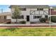 Charming two-story home with a well-manicured lawn and mature landscaping at 163 Greenbriar Townhouse Way, Las Vegas, NV 89121