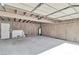 Unfinished garage interior with wood paneling and concrete floors at 163 Greenbriar Townhouse Way, Las Vegas, NV 89121