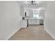 Charming kitchen featuring white cabinets, stainless steel appliances, and modern lighting at 163 Greenbriar Townhouse Way, Las Vegas, NV 89121