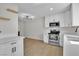 Bright kitchen features white cabinets, stainless steel appliances, and modern light fixture at 163 Greenbriar Townhouse Way, Las Vegas, NV 89121