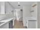 Bright and modern kitchen featuring white cabinets, quartz countertop and stainless steel appliances at 163 Greenbriar Townhouse Way, Las Vegas, NV 89121