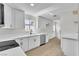 Bright kitchen features white cabinets, stainless steel appliances, and a view to the backyard at 163 Greenbriar Townhouse Way, Las Vegas, NV 89121
