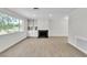 Bright living room with modern floors, fireplace and large window overlooking the yard at 163 Greenbriar Townhouse Way, Las Vegas, NV 89121