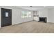 Bright living room with modern floors, fireplace and large window overlooking the yard at 163 Greenbriar Townhouse Way, Las Vegas, NV 89121