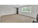 Bright living room with modern floors and a large window overlooking the yard at 163 Greenbriar Townhouse Way, Las Vegas, NV 89121