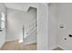 Bright stairway featuring white trim, carpeted steps, and a laundry closet at 163 Greenbriar Townhouse Way, Las Vegas, NV 89121