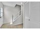 Cozy stairway featuring white trim, carpeted steps, and natural lighting at 163 Greenbriar Townhouse Way, Las Vegas, NV 89121