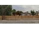 Street view of a single-story home featuring a horizontal wood fence for added privacy and a neatly maintained front yard at 1834 E Bonanza Rd, Las Vegas, NV 89101