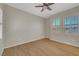 Bright bedroom with wood floors, ceiling fan, and natural light from shuttered windows at 2039 Colvin Run Dr, Henderson, NV 89052