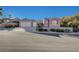 Single-story home with a three-car garage, desert landscaping, and mountain views at 2039 Colvin Run Dr, Henderson, NV 89052