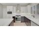 Modern kitchen with white cabinets, stainless appliances, and a stylish range hood at 2039 Colvin Run Dr, Henderson, NV 89052