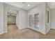 Bright living room with wood floors, white walls, glass panel doors and view of adjacent room at 2039 Colvin Run Dr, Henderson, NV 89052