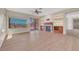 Living room with hardwood floors, ceiling fan, fireplace, and built-in shelves at 2039 Colvin Run Dr, Henderson, NV 89052