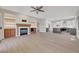 Open living room with fireplace, built-ins, hardwood floors, and access to the kitchen at 2039 Colvin Run Dr, Henderson, NV 89052