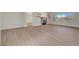 Spacious living room with wood floors, fireplace, open shelving, recessed lights, and backyard views at 2039 Colvin Run Dr, Henderson, NV 89052