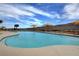 Resort-style community pool with lounge chairs and mountain views under a sunny sky at 2039 Colvin Run Dr, Henderson, NV 89052