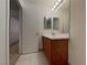 Bathroom featuring a wood vanity, white tile, and neutral walls at 209 Copper Pine Ave, North Las Vegas, NV 89031