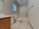 Bathroom featuring a tub-shower combo, white tile, and a wood vanity at 209 Copper Pine Ave, North Las Vegas, NV 89031