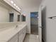 Bathroom featuring a long vanity with a large mirror, and a view into the main bedroom at 209 Copper Pine Ave, North Las Vegas, NV 89031