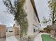 View of the side of the house with lush greenery and a pathway, set against a cloudy sky at 209 Copper Pine Ave, North Las Vegas, NV 89031