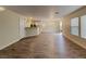 A bright and spacious living room featuring modern wood-look flooring and natural light streaming through large windows at 209 Copper Pine Ave, North Las Vegas, NV 89031