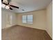Spacious main bedroom with a ceiling fan, neutral carpet, and an ensuite bathroom at 209 Copper Pine Ave, North Las Vegas, NV 89031