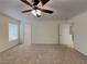 Spacious main bedroom with neutral carpet, a ceiling fan, and a walk-in closet at 209 Copper Pine Ave, North Las Vegas, NV 89031