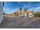 The backyard features new french doors with lounge chairs and a blank canvas to create the yard of your dreams! at 210 E Longacres Dr, Henderson, NV 89015
