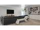 Finished basement features an entertainment area with a modern couch and television at 210 E Longacres Dr, Henderson, NV 89015