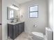 Renovated bathroom features double sinks, contemporary lighting, and a neutral color palette at 210 E Longacres Dr, Henderson, NV 89015