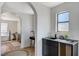 This bathroom features an arched entrance, modern sink, and bathtub at 210 E Longacres Dr, Henderson, NV 89015