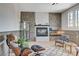 Bright living room with stone fireplace, hardwood floors, modern furniture and large windows providing natural light at 210 E Longacres Dr, Henderson, NV 89015